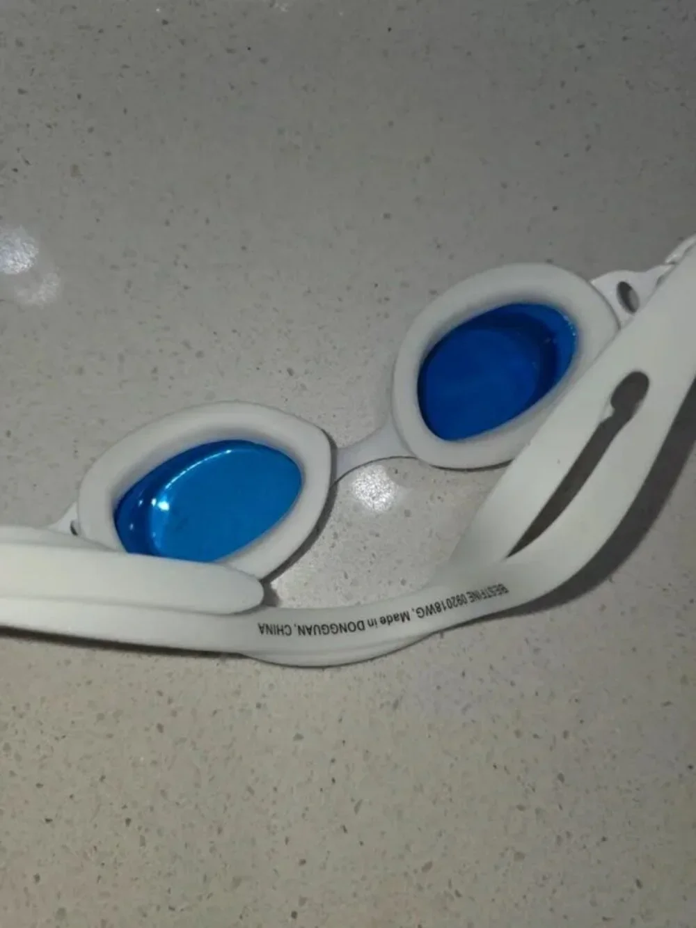 Silicone swim goggles with blue mirrored lenses, white frame, unisex racing styl